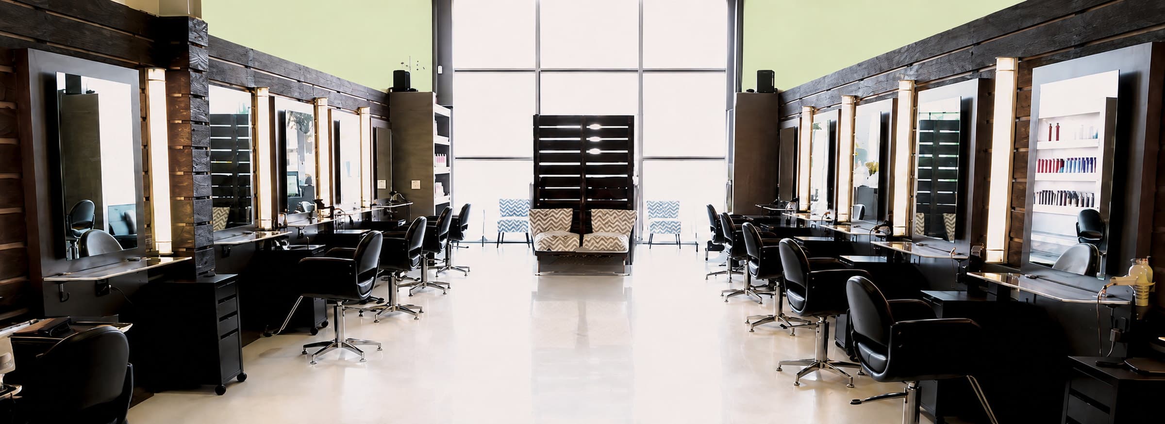 The FÜMA Salon floor on Melrose Avenue, mirror stations along both walls under the front windows